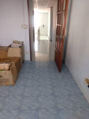 hallway with tiled floor and wooden door