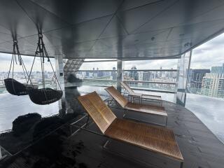 Luxury building with rooftop pool and city view