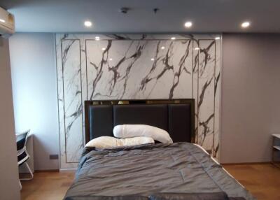 Modern bedroom with marble accent wall