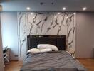 Modern bedroom with marble accent wall