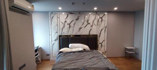 Modern bedroom with marble accent wall