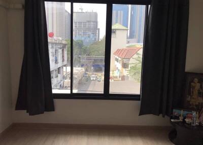 Bedroom with a large window view of the city