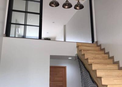 Staircase and loft area with modern lighting