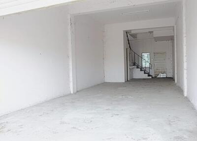 Empty garage space with a staircase in the background