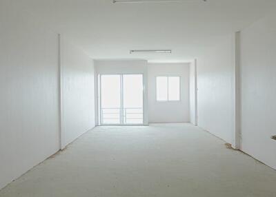 Minimalist empty room with white walls and sliding glass door