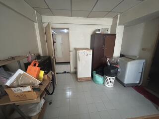 A utility room with various appliances and storage items