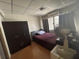 Bedroom with bed, wardrobe, air conditioner, and fan