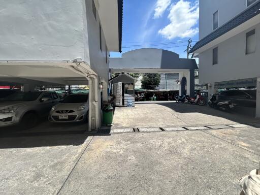 Parking area with multiple cars under a building