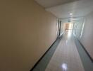 Hallway with tile flooring and overhead lighting