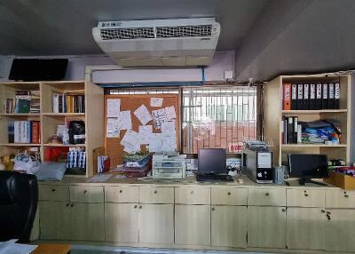 Office space with shelves, desk, and equipment