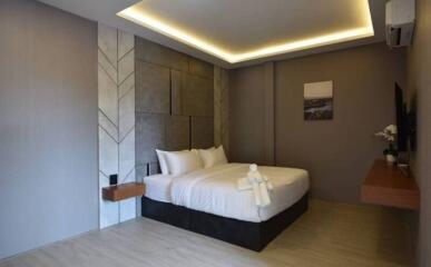 Modern bedroom with accent wall and lighting