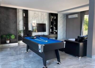 Modern living room with pool table and television