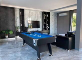 Modern living room with pool table and television