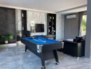 Modern living room with pool table and television