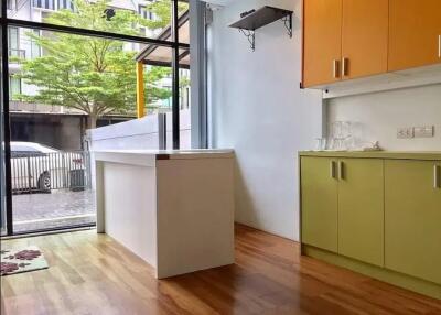 Modern kitchen with minimalistic design, featuring a large window.