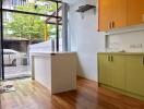 Modern kitchen with minimalistic design, featuring a large window.