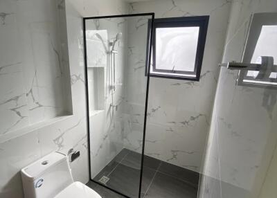 Modern bathroom with glass-enclosed shower and large window