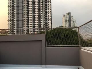 View of city buildings from a balcony