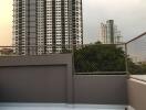 View of city buildings from a balcony