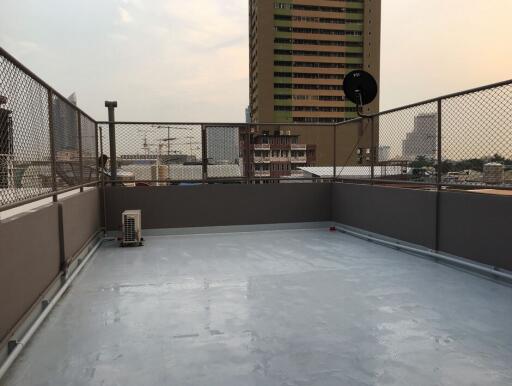 Rooftop with fence and city view