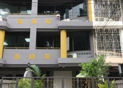 Modern multi-storey residential building exterior with balconies and decorative elements