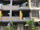 Modern multi-storey residential building exterior with balconies and decorative elements