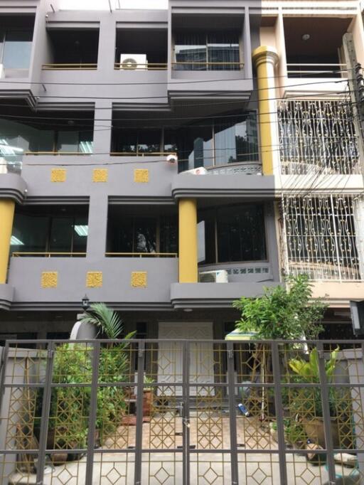 Modern multi-storey residential building exterior with balconies and decorative elements