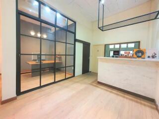 Modern office space with glass partition and reception desk