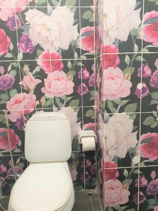 Bathroom with floral wall tiles and toilet