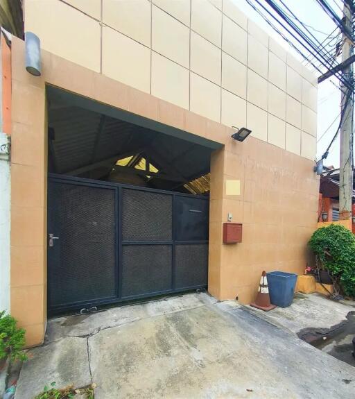 Front view of the property showing the entrance gate and exterior wall