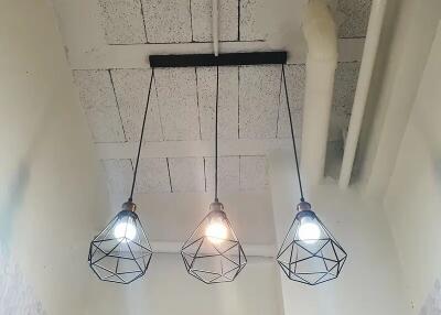 Modern pendant lights hanging from a high ceiling