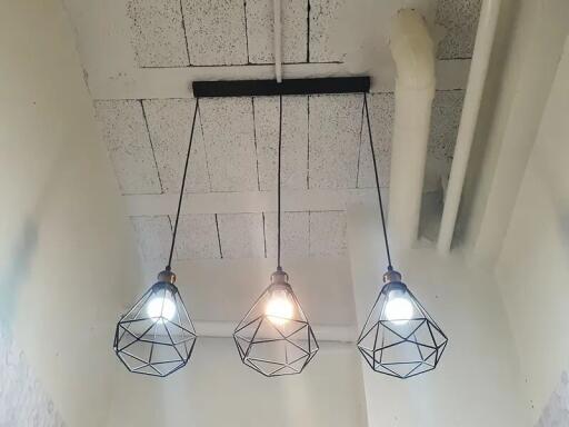 Modern pendant lights hanging from a high ceiling