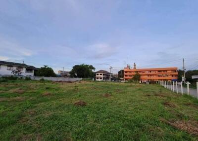 Vacant lot with buildings in the background