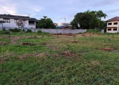 Spacious open plot of land with surrounding houses