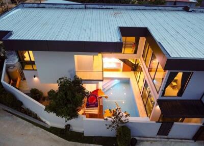 Aerial view of modern two-story house with indoor swimming pool