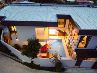 Aerial view of modern two-story house with indoor swimming pool