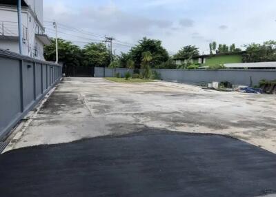 Spacious paved area with surrounding greenery