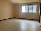 Spacious empty living room with large window