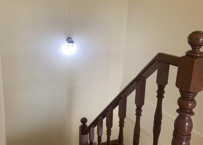 Wooden staircase with light fixture