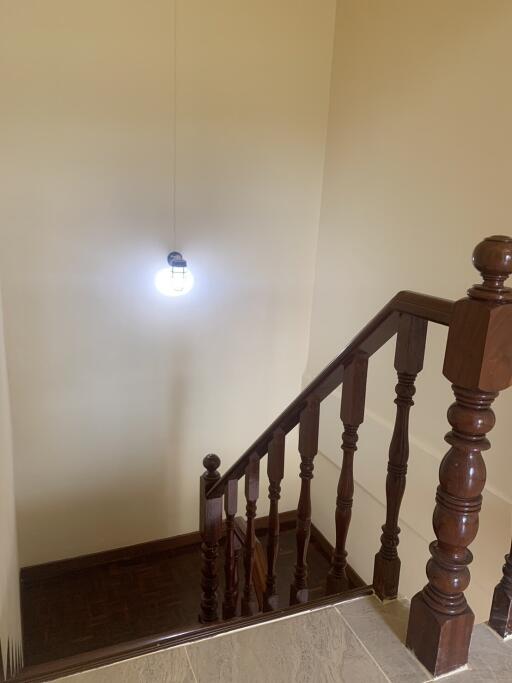 Wooden staircase with light fixture