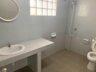 Bathroom with shower, sink, and toilet