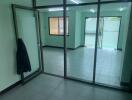 Empty living area with glass partition wall