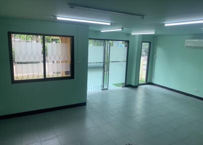 Spacious living room with large windows and tiled floor