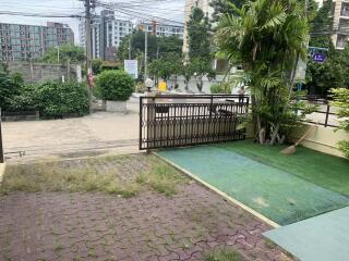 front yard with gate and sidewalk