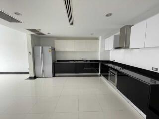 Modern kitchen with black and white cabinetry and stainless steel appliances