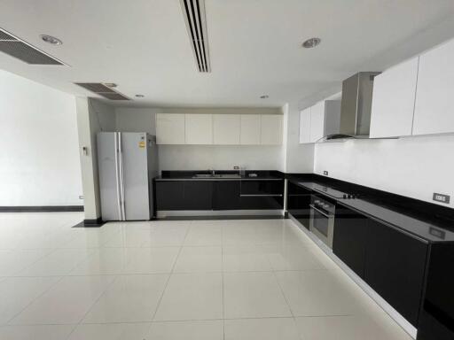 Modern kitchen with black and white cabinetry and stainless steel appliances