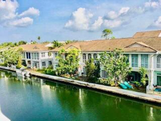 Scenic view of waterfront residential buildings with lush greenery