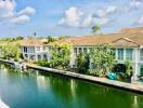 Scenic view of waterfront residential buildings with lush greenery