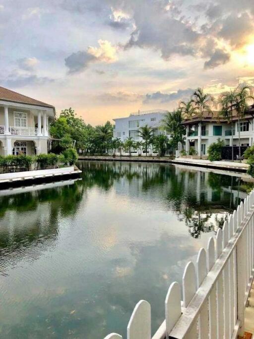 Scenic view of a pond surrounded by houses