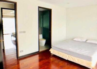 Spacious bedroom with ensuite bathroom and wooden flooring
